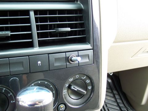 2003 Ford Crown Victoria - Close-up of a vehicle's dashboard, showing climate control knobs and air vents.