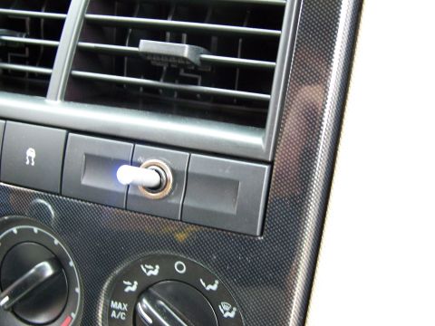 2003 Ford Crown Victoria - Close-up of a vehicle's interior dashboard, showing air vents and climate control knobs.