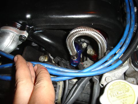 1995 Mazda MX-6 - Engine bay details with braided hose and blue spark plug wires visible.