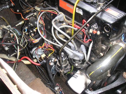 1979 Four Winns 170 Horizon - Boat engine compartment showing complex wiring and engine components. Oil filter is visible.