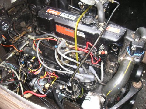 1979 Four Winns 170 Horizon - A close-up view of a boat engine's internal components and wiring, with a visible "140" marking.