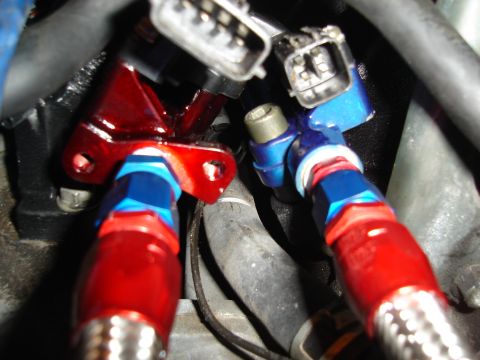 1995 Mazda MX-6 - Modified fuel injectors and lines, likely for a performance engine build.
