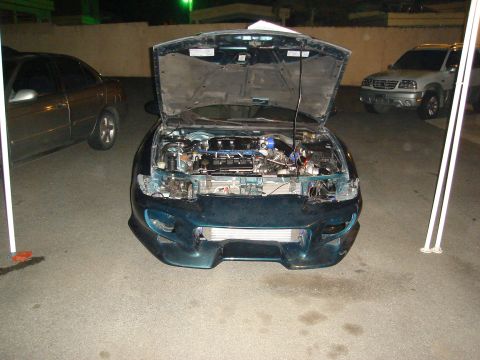 1995 Mazda MX-6 - This 1995 Mazda MX-6 is shown with its hood open, revealing the engine bay and an aftermarket intercooler.