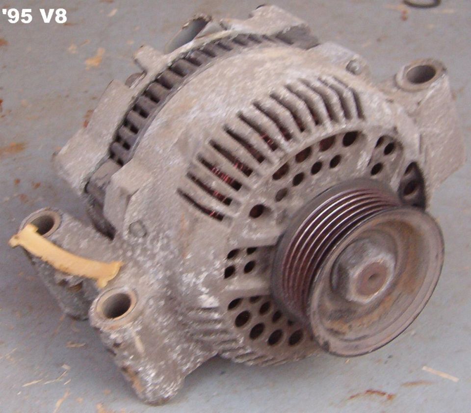 Used automotive alternator on a concrete floor labeled 95 V8