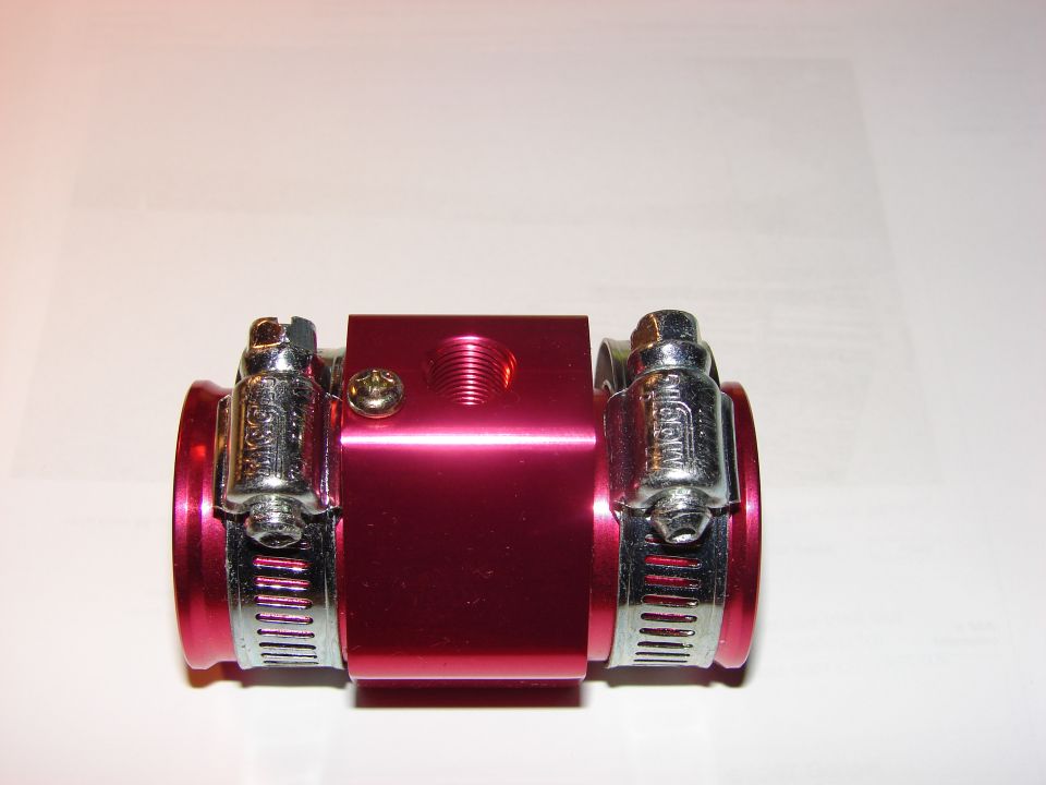 Red aluminum water temperature fitting with two hose clamps attached