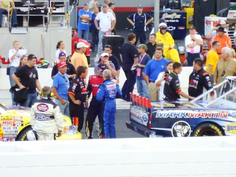 1995 Ford Bronco - Pit crew members and race cars are gathered at a NASCAR event. One car is branded with 'MARK MARTIN'.