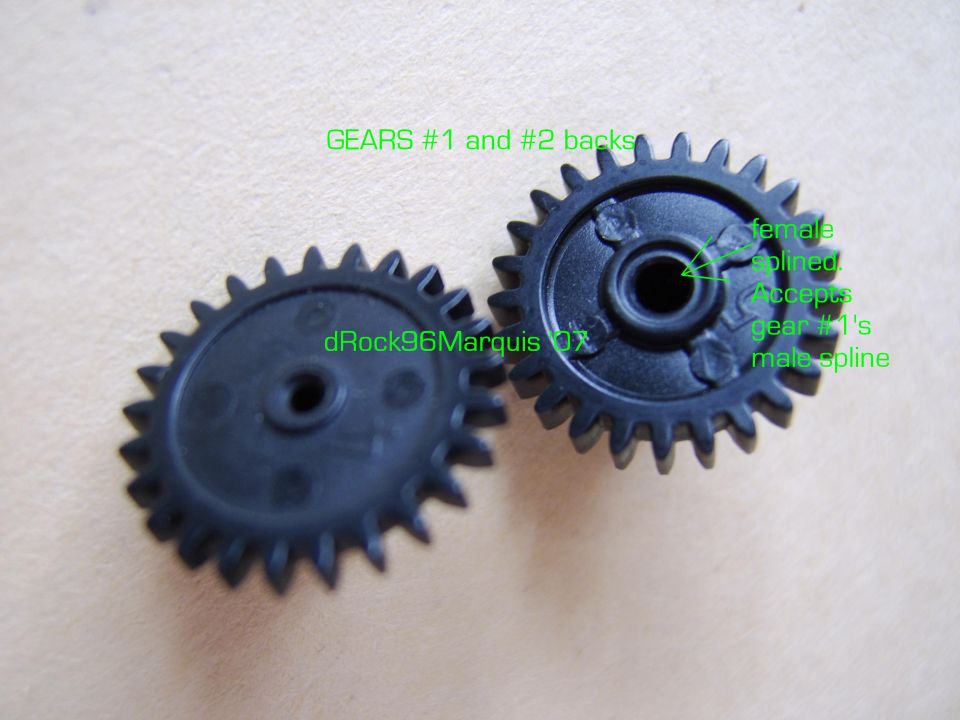 Two small black plastic gears shown from the back, annotated