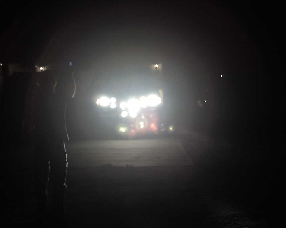 Vehicle lights illuminated at night