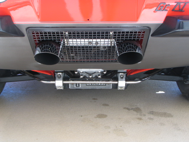 Dual exhaust pipes exiting through a rear grille, with 'ULTRA 50' visible on a component below