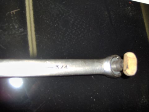 1978 Ford Bronco - A close-up view of a metal rod with a wooden knob and threaded end, marked with "- 3/4".