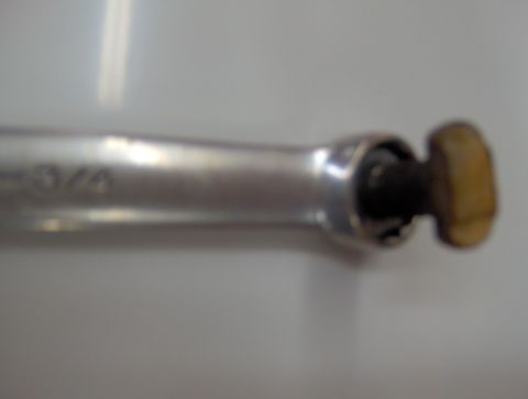 1978 Ford Bronco - A close-up view of a ratchet tool, showing the "3/4" marking on its metallic body.