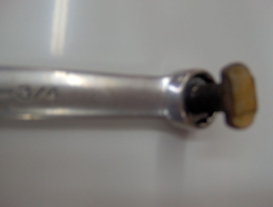 Close-up of a ratchet tool with "3/4" visible on the handle