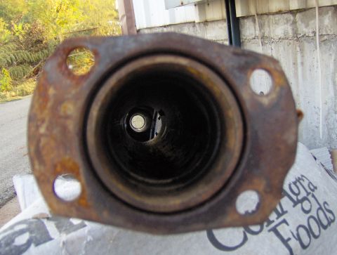 1978 Ford Bronco - A rusty exhaust pipe flange is shown, with a view into the connected pipe.