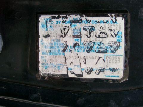 1989 Ford Bronco - Close-up of a 1989 Ford VIN sticker, showing manufacturing details and identification numbers.