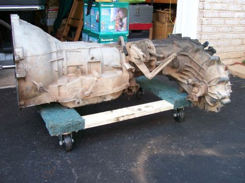 1989 Ford Bronco - A Ford transmission and transfer case assembly is shown on a wheeled dolly.