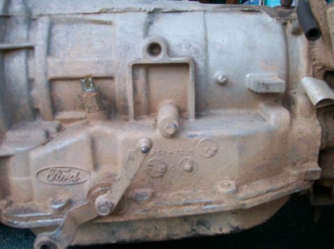 1989 Ford Bronco - Close-up of a Ford transmission casing, showing the embossed Ford logo and some part numbers.