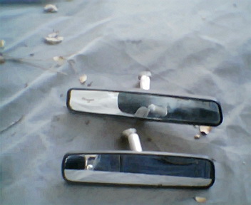 1973 Ford Ranchero - Two chrome rearview mirrors are shown, one with a cracked glass surface.