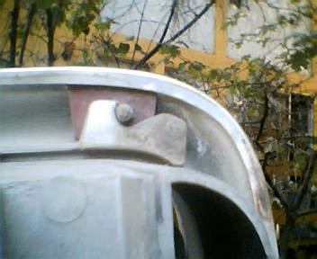 1973 Ford Ranchero - A close-up view of a vehicle's metallic component, highlighting its construction and fasteners.