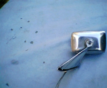 1973 Ford Ranchero - Close-up of a chrome door handle and side mirror assembly.