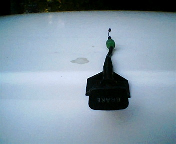 1973 Ford Ranchero - A close-up view of a black parking brake release lever, showing the word "BRAKE" embossed on it.