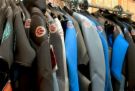 1992 Ford Bronco - A selection of wetsuits are displayed on hangers, ready for use.