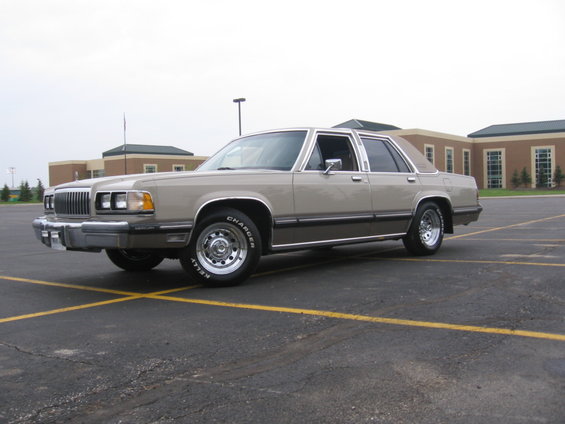 Tan Mercury sedan front three-quarter view with chrome grille