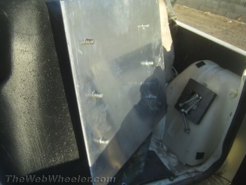 1987 Suzuki Samurai - A metal bracket with bolts is shown, possibly a spare part or modification.
