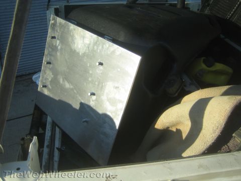 1987 Suzuki Samurai - A custom metal panel is installed inside a vehicle, obscuring some of the interior components.