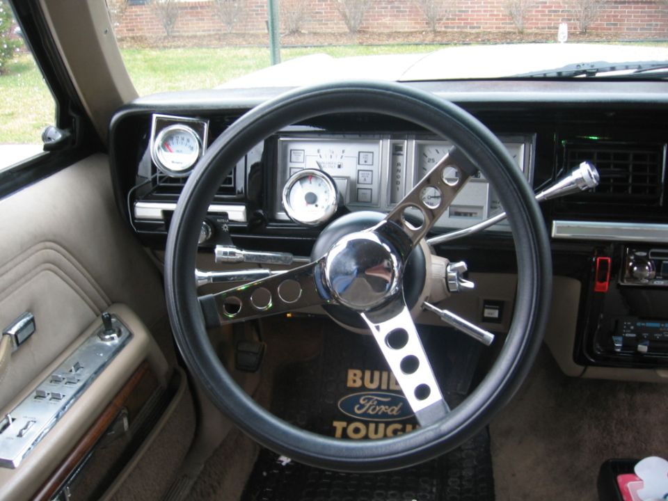 Close view of car gauge cluster and aftermarket steering wheel