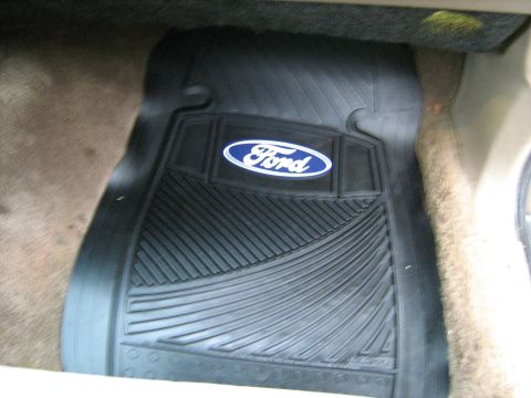 1988 Mercury Grand Marquis - A black floor mat with the Ford logo is visible on the interior floor of a vehicle.