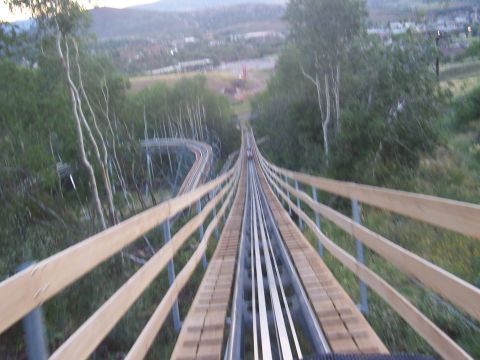1972 Ford Ranchero - A scenic view from the top of an alpine slide track, descending through a wooded area with a town visible in the background.