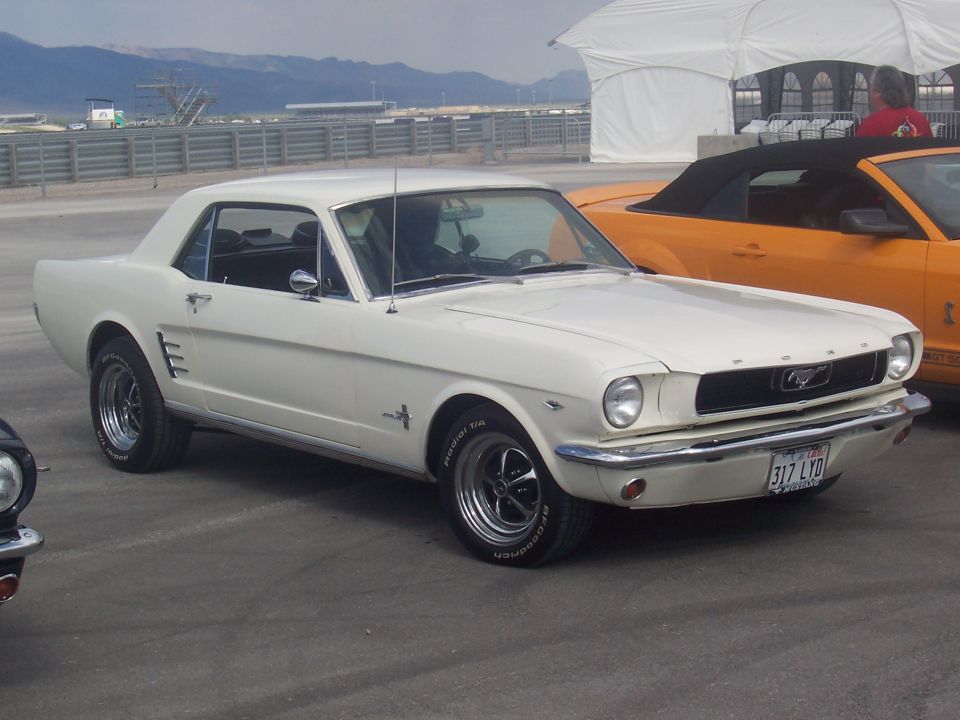 White 1965 Ford Mustang coupe, 3q front view. License plate 317 LYD