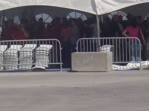 1972 Ford Ranchero - A crowd of people are visible behind metal barricades and a large white tent.