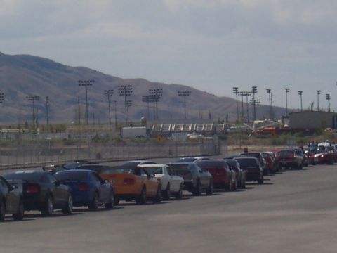 1972 Ford Ranchero - Multiple cars are parked in a row, with stadium lights and mountains visible behind them.