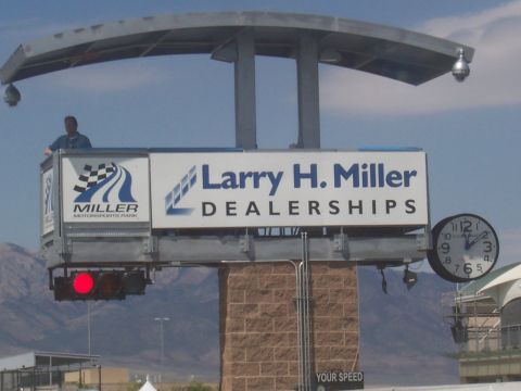 1972 Ford Ranchero - A billboard displays "Larry H. Miller Dealerships" and "Miller Motorsports Park" alongside a clock and traffic signal.