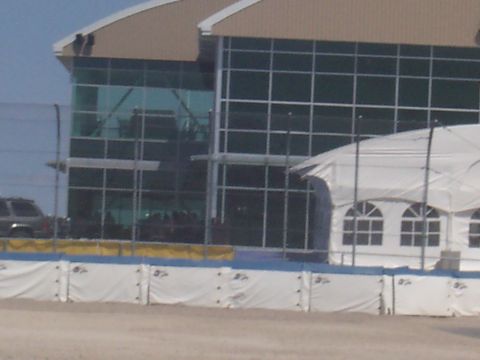 1972 Ford Ranchero - A dark SUV is visible in the background near a modern building and a white tent.