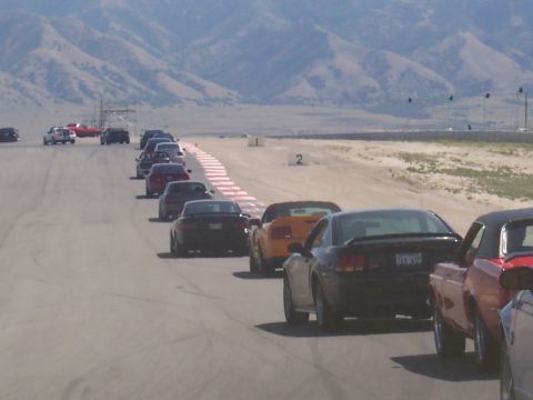 1972 Ford Ranchero - A line of cars waits on the track, with mountains visible in the distance.