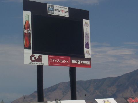 1972 Ford Ranchero - A large scoreboard displays advertisements for Coca-Cola, Ford, Zions Bank, and Big O Tires.