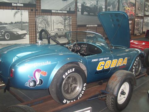 1972 Ford Ranchero - A blue Cobra race car with "Dragonsnake" and "COBRA" graphics is displayed with its hood open.