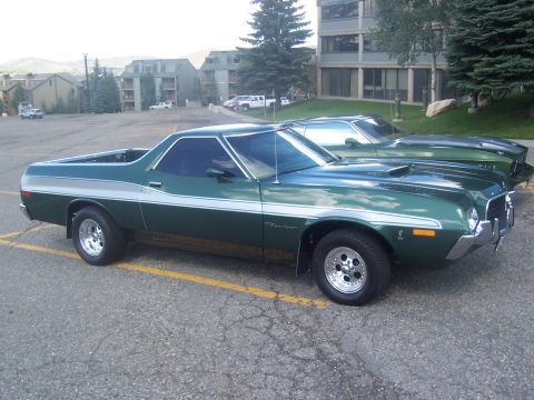 1972 Ford Ranchero - A green 1972 Ford Ranchero is parked next to another vehicle in a parking lot.