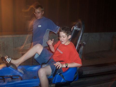 1972 Ford Ranchero - Two people enjoy a nighttime ride on a luge or roller coaster.