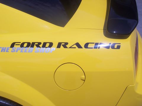 1972 Ford Ranchero - A yellow vehicle displays 'FORD RACING' and 'THE SPEED SHOP' graphics on its rear quarter panel.