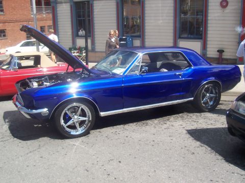 1972 Ford Ranchero - Blue 1967 Ford Mustang coupe, hood open, parked on street next to red convertible.