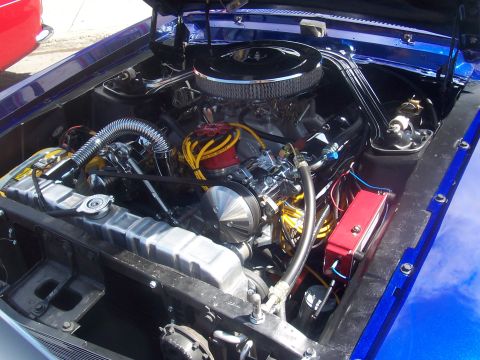 1972 Ford Ranchero - The engine compartment of a blue vehicle is shown with various engine components and wiring.