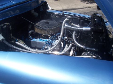 1972 Ford Ranchero - Engine bay of a blue car, showing the engine, radiator, and various hoses.