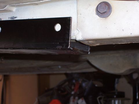 1978 Ford Mustang II - Close-up view of a black metal bracket attached to the underbody frame of a vehicle.