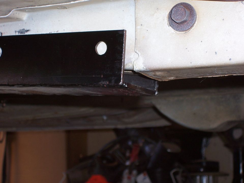 Underbody frame with black metal bracket and bolt