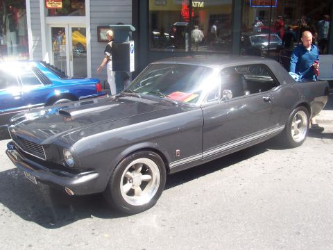 1972 Ford Ranchero - A classic gray Ford Mustang is parked on the street, with a blue car visible to its left.