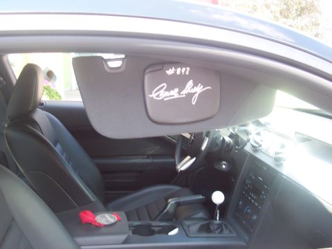 1972 Ford Ranchero - Car interior with signed sun visor and a medal on the center console.