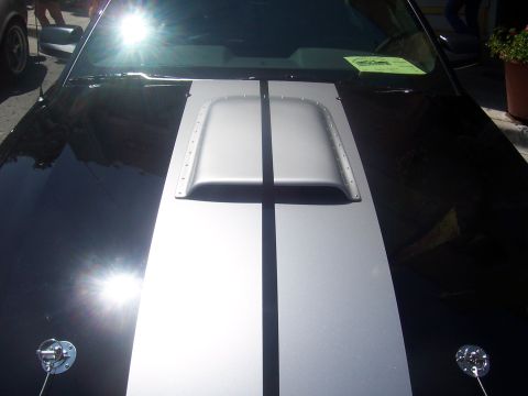 1972 Ford Ranchero - A close-up view of a car's hood, silver racing stripes and a prominent hood scoop.